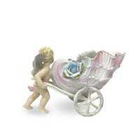 Porcelain Cherub Pushing a Seashell Wheelbarrow