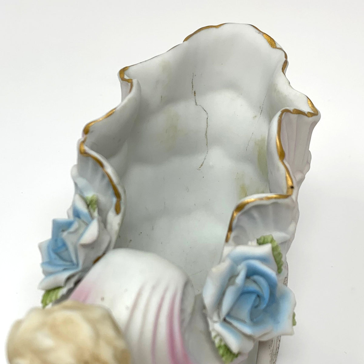 Porcelain Cherub Pushing a Seashell Wheelbarrow