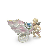 Porcelain Cherub Pushing a Seashell Wheelbarrow